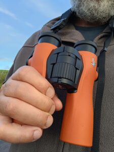 A man reviewing the Swarovski Optik NL Pure 10x32 Binoculars.